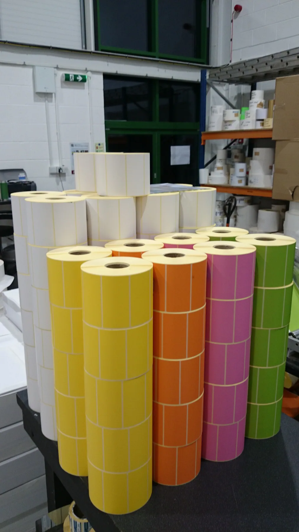 Genuine photograph of multicoloured printed label reels in Northern Labels production