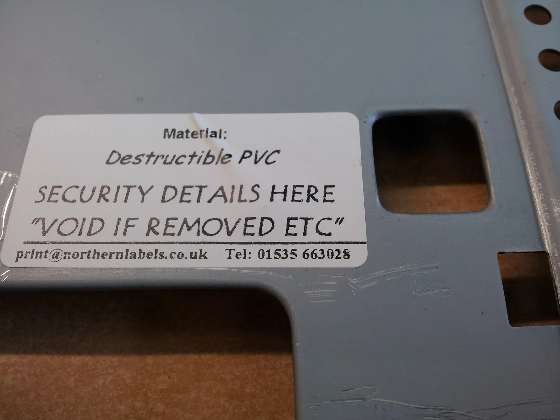 Actual security label applied to equipment fixing